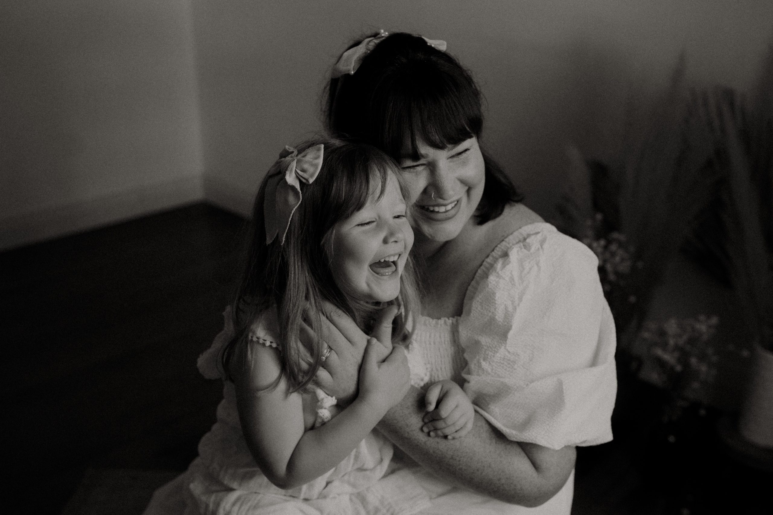Black and white photo of Melanie Edge Perth Photographer for women kissing her little girl's cheek